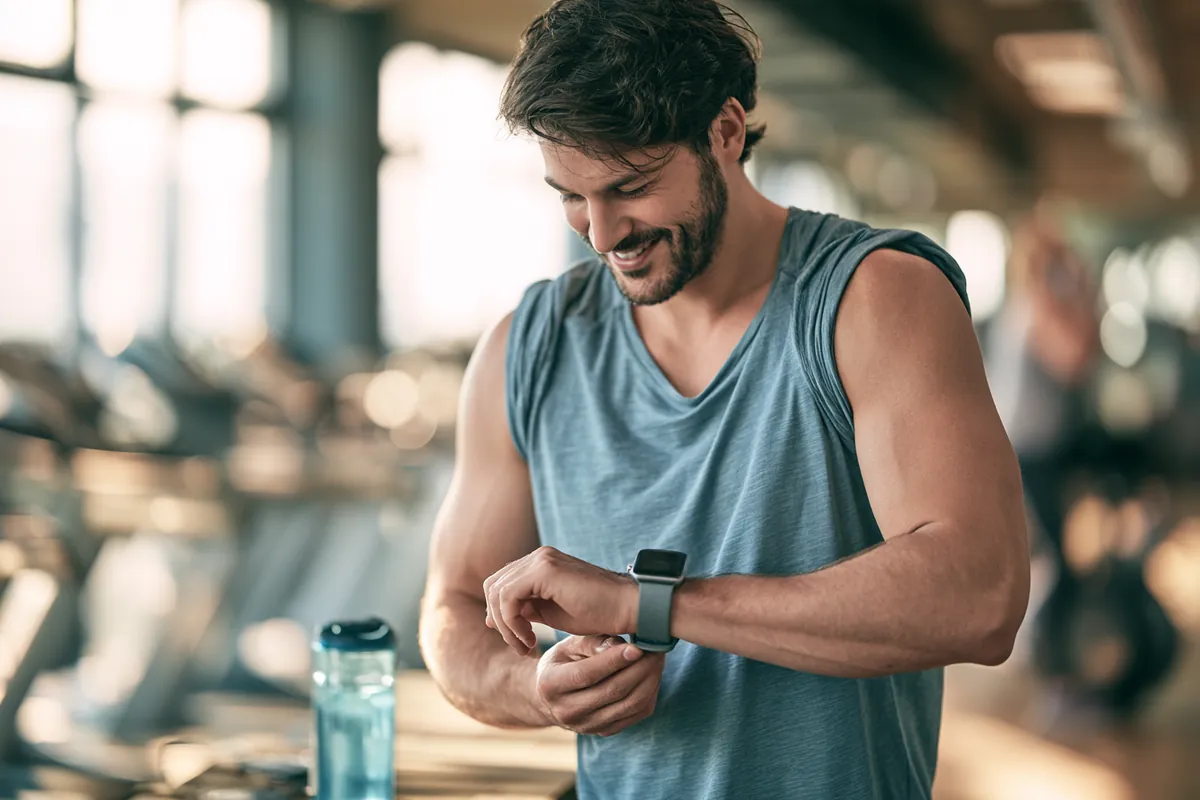 Man in his 30s checking his smartwatch after a gym workout, as quick as a Willow Lake Loan rate check